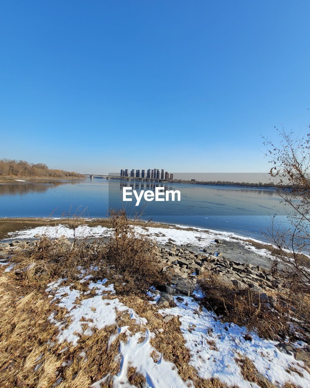 winter, water, reflection, nature, blue, snow, day, no people, beauty in nature, sky, scenics - nature, tree, tranquility, mountain, outdoors, cold temperature, land, plant, ice, clear sky, sunlight, tranquil scene, sea, environment, beach, landscape, non-urban scene
