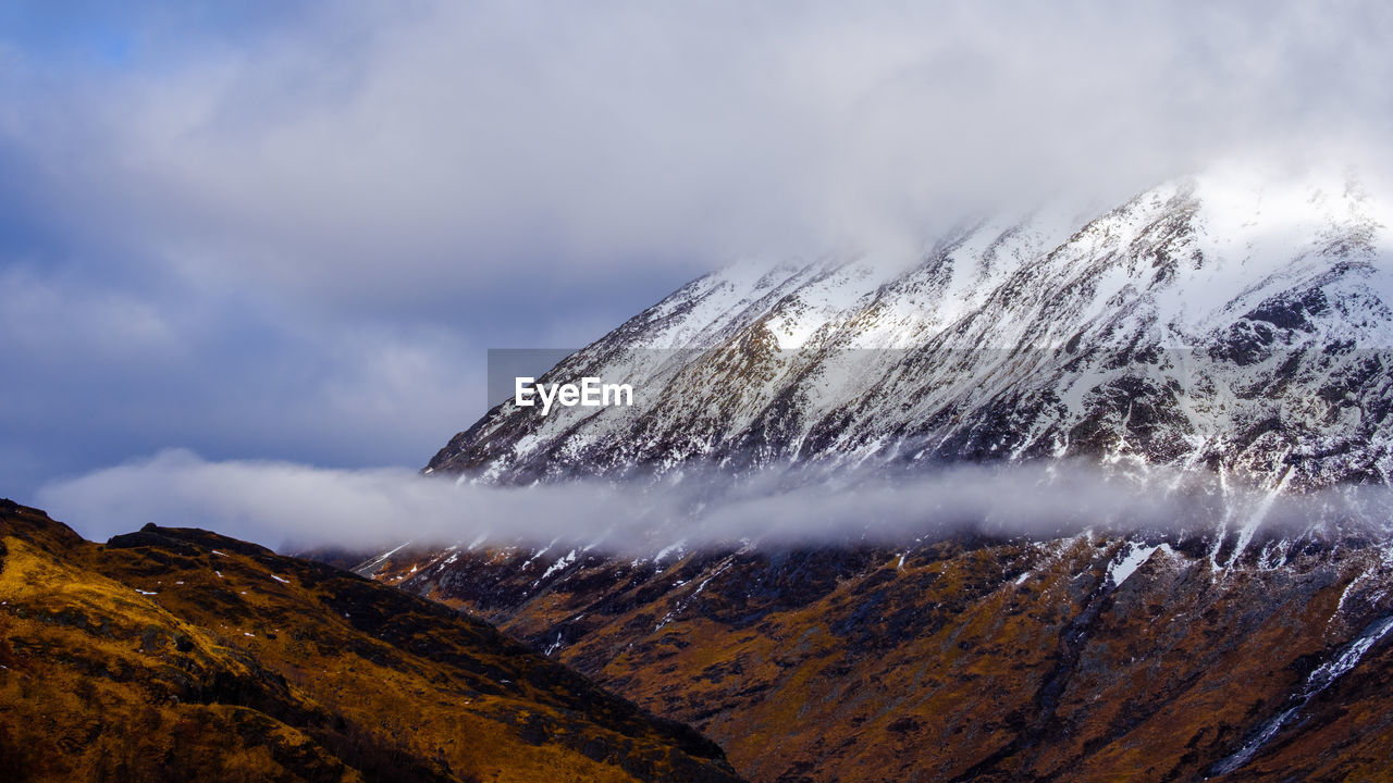 Close-up of snow covered mountain against sky