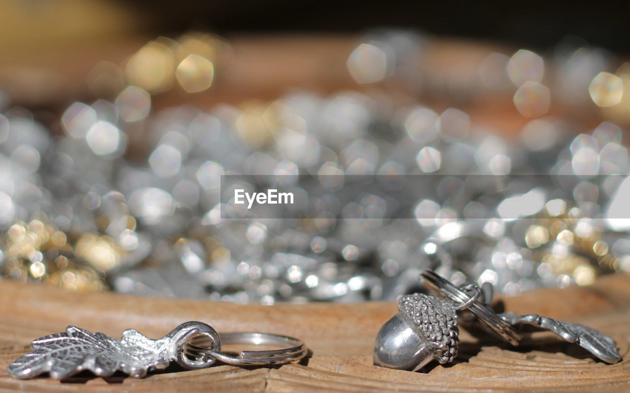 Close-up of silver key rings on wooden container