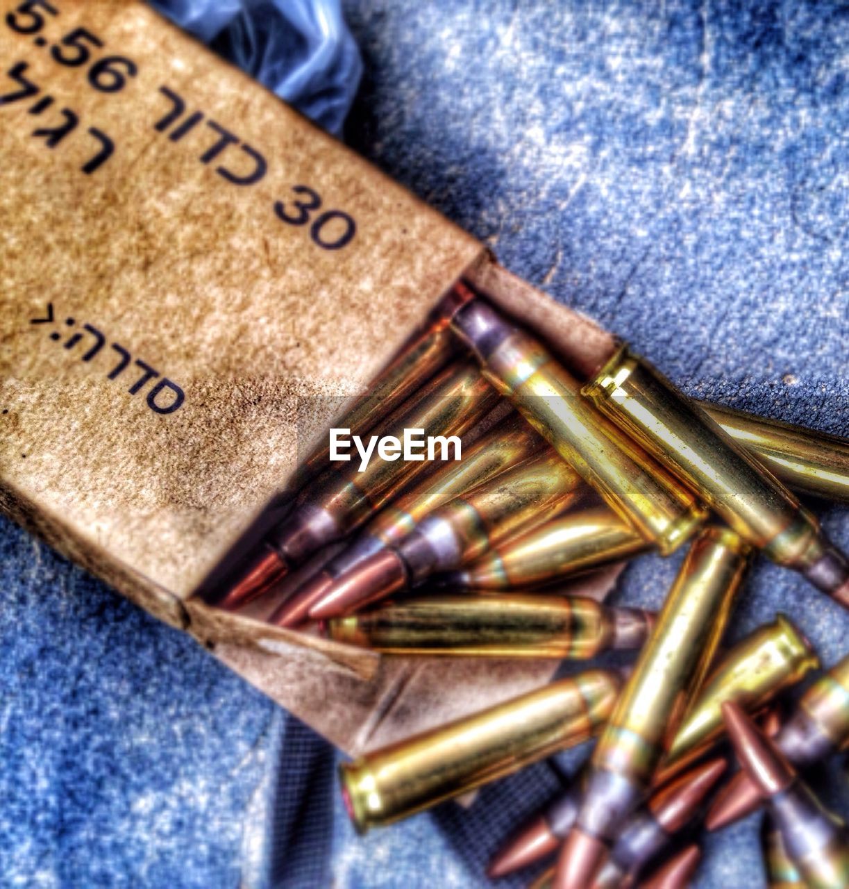 High angle view of bullets on fabric
