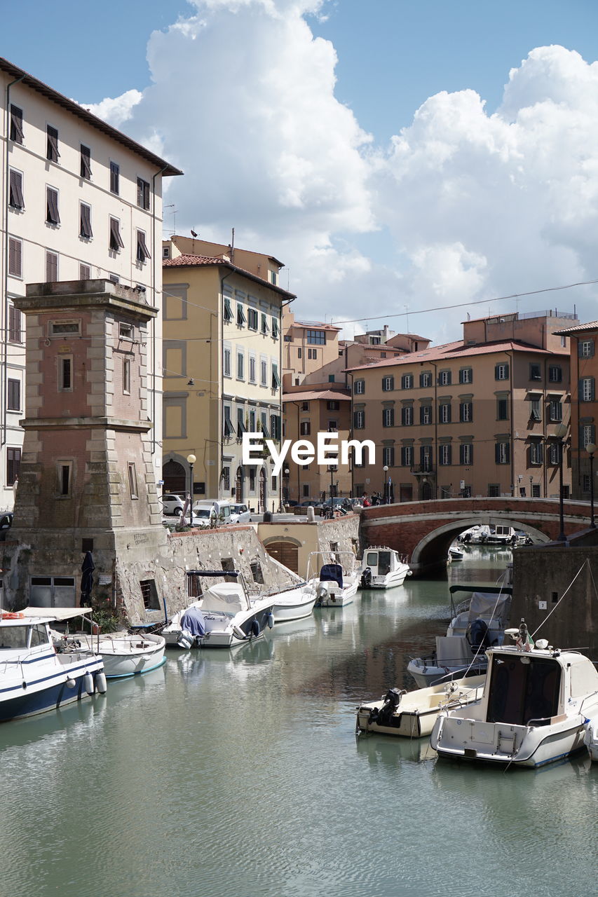 Boats moored on canal in a sunny day in livorno