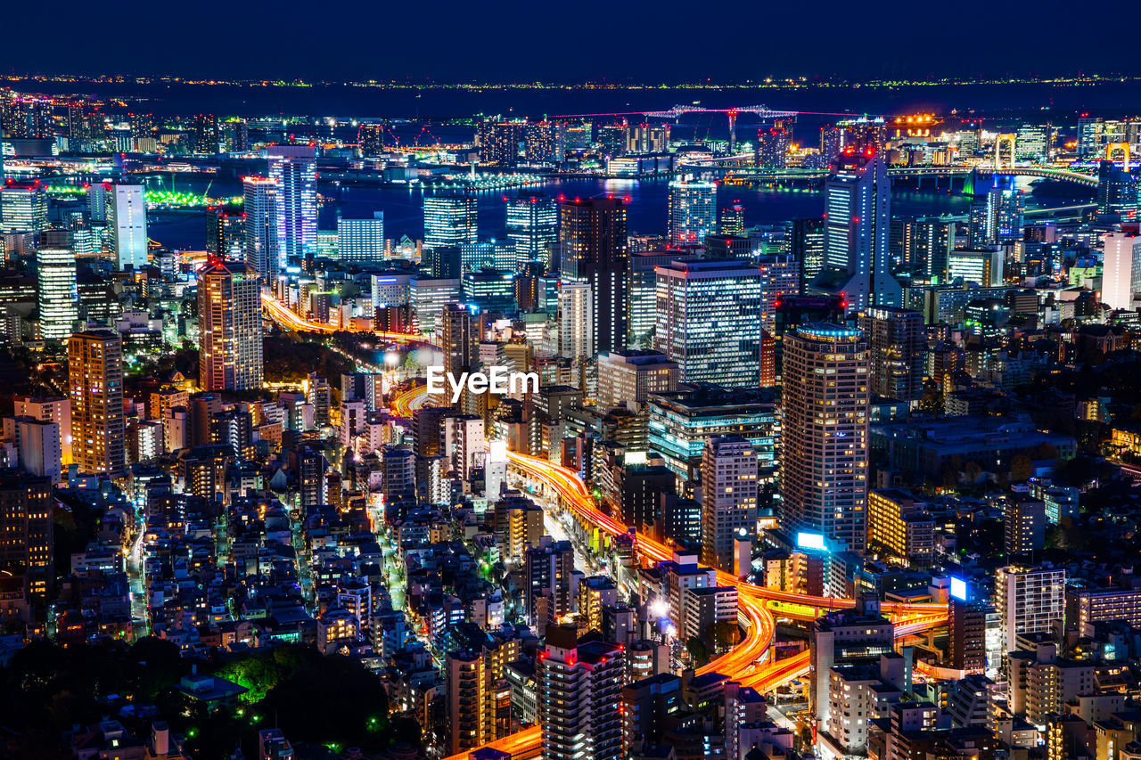 HIGH ANGLE VIEW OF ILLUMINATED CITY AT NIGHT