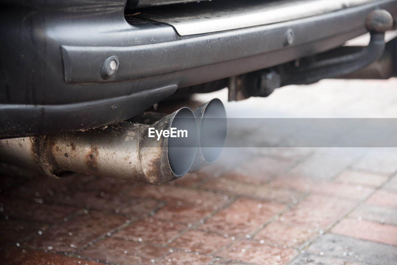 Close-up of car pipes emitting smoke