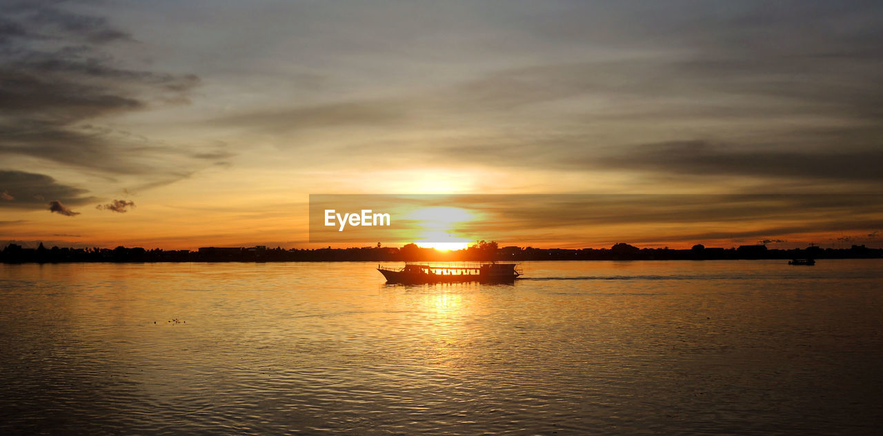 SCENIC VIEW OF SEA AGAINST ORANGE SKY DURING SUNSET