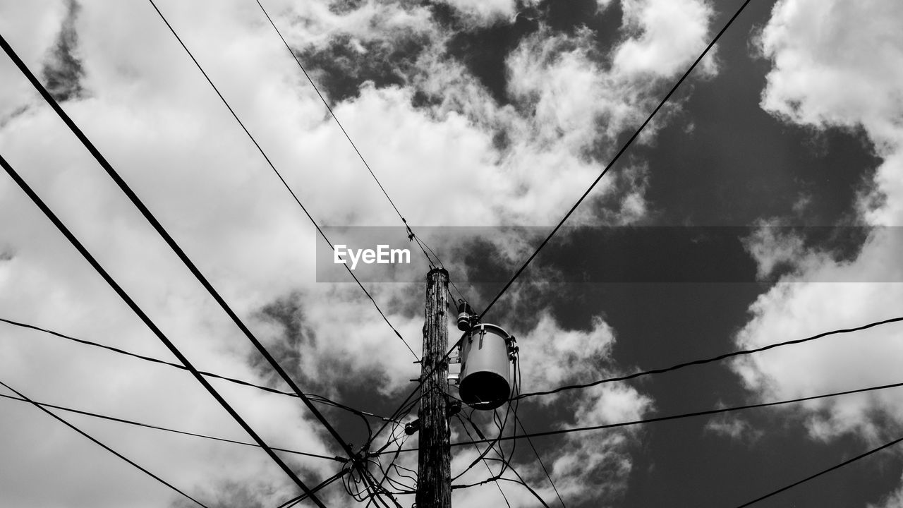 Low angle view of electricity pylon against sky