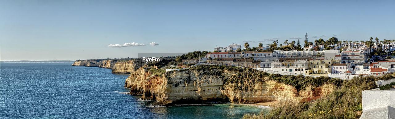 Panoramic view of sea and buildings against sky