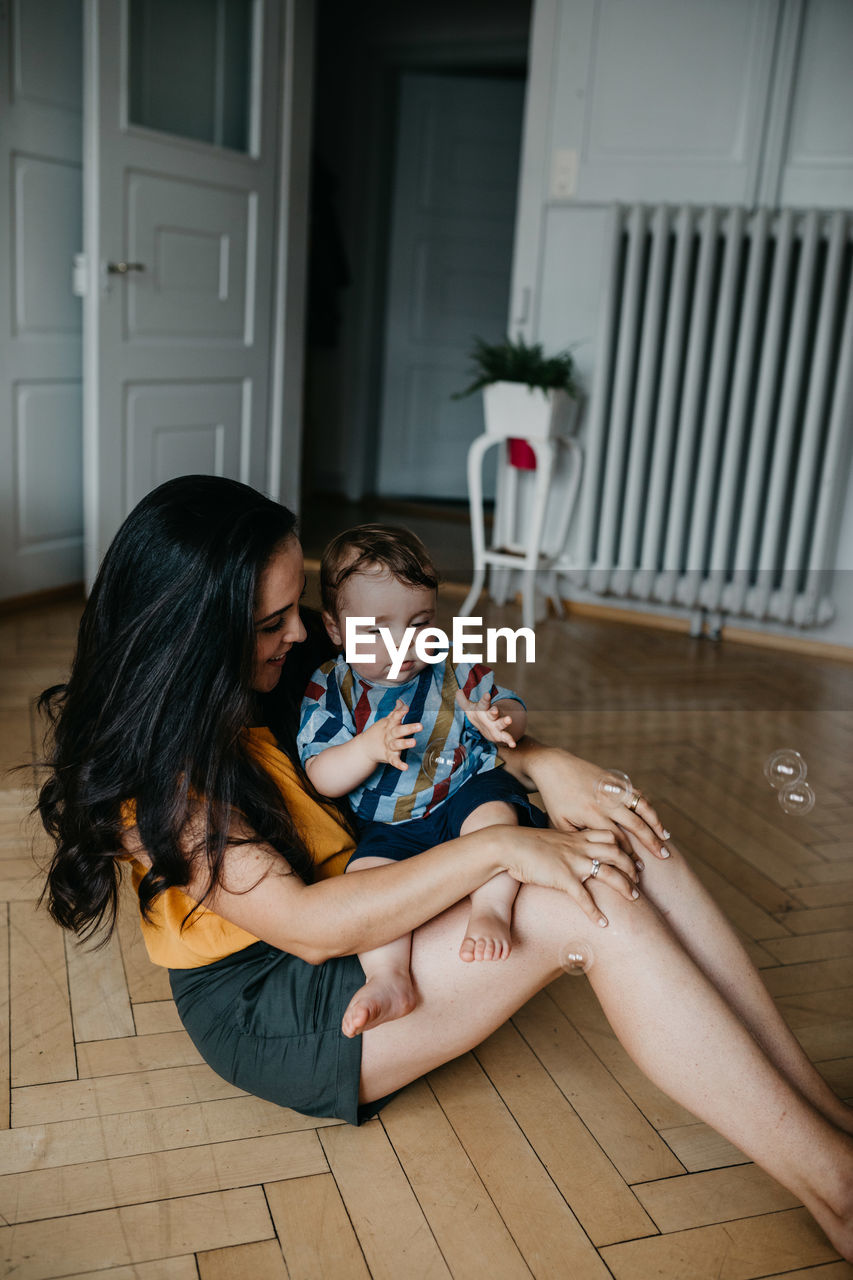 Mother sitting with toddler son at home