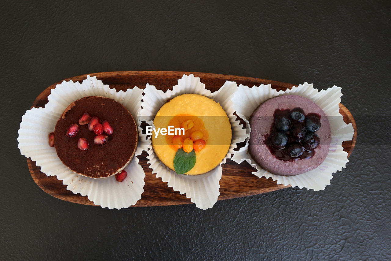 food and drink, food, freshness, sweet food, sweet, dessert, healthy eating, fruit, cake, plate, indoors, directly above, table, flower, icing, baked, cupcake, muffin, still life, temptation, studio shot, high angle view, no people, berry, meal, wood, sweetness, wellbeing, chocolate