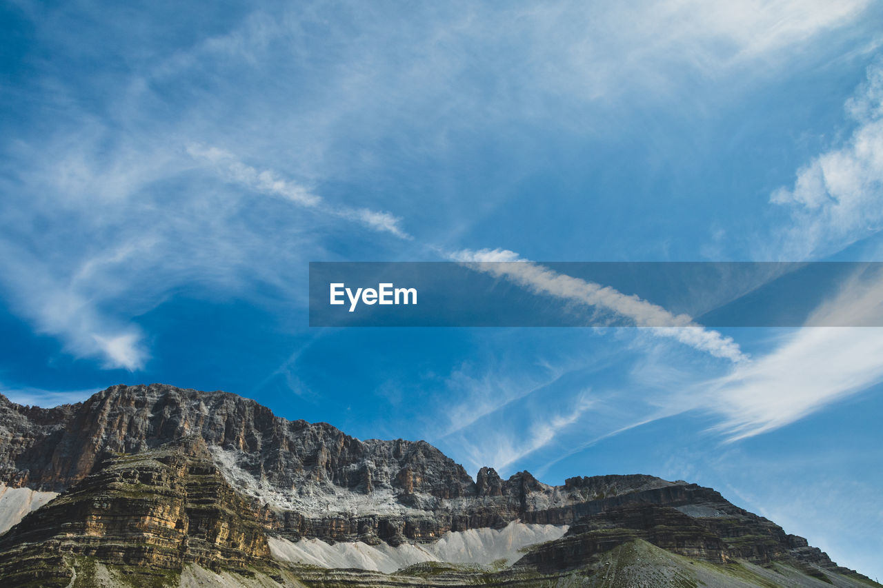 Low angle view of mountain against blue sky