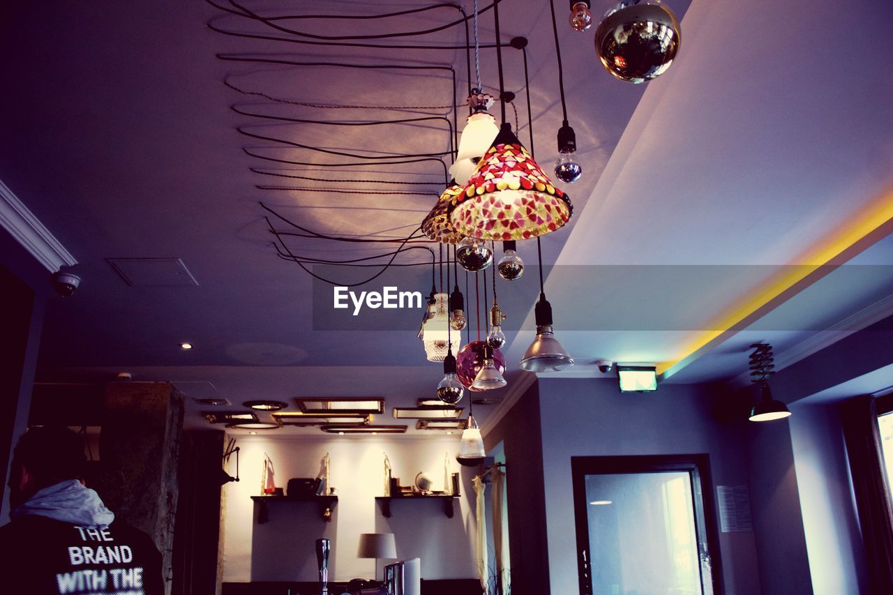 LOW ANGLE VIEW OF ILLUMINATED LANTERN HANGING ON CEILING