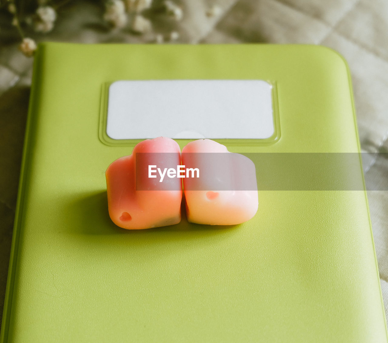 High angle view of heart shaped candies on green diary