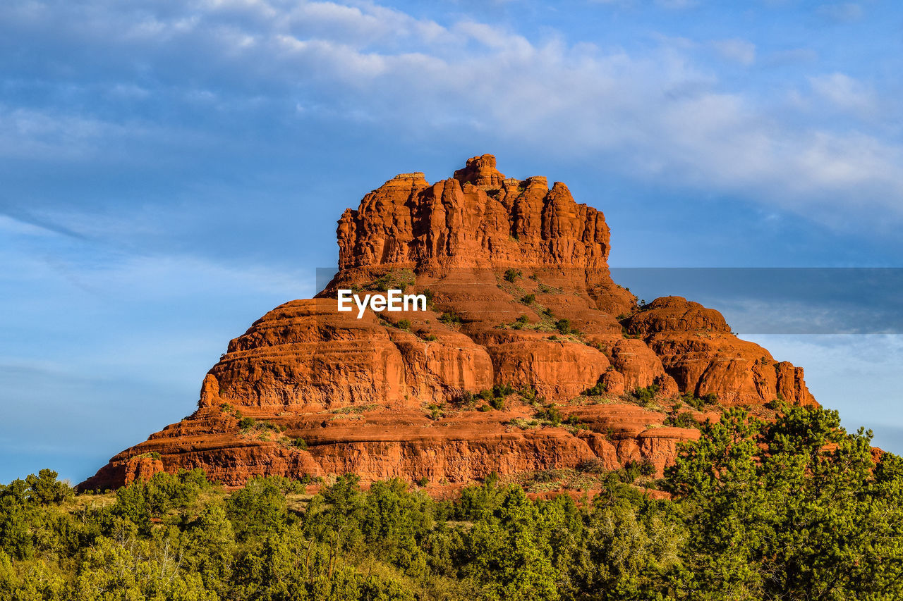 Low angle view of rock formation against cloudy sky