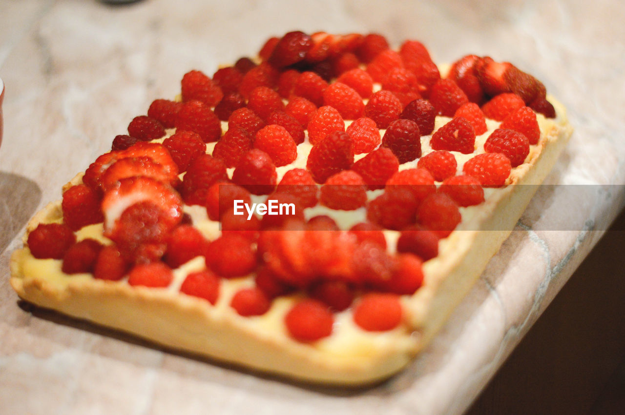 CLOSE-UP OF CAKE WITH STRAWBERRIES