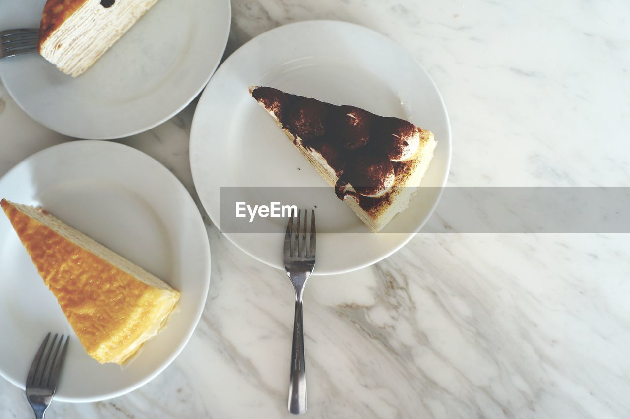 Directly above view of cake pieces in plate on marble