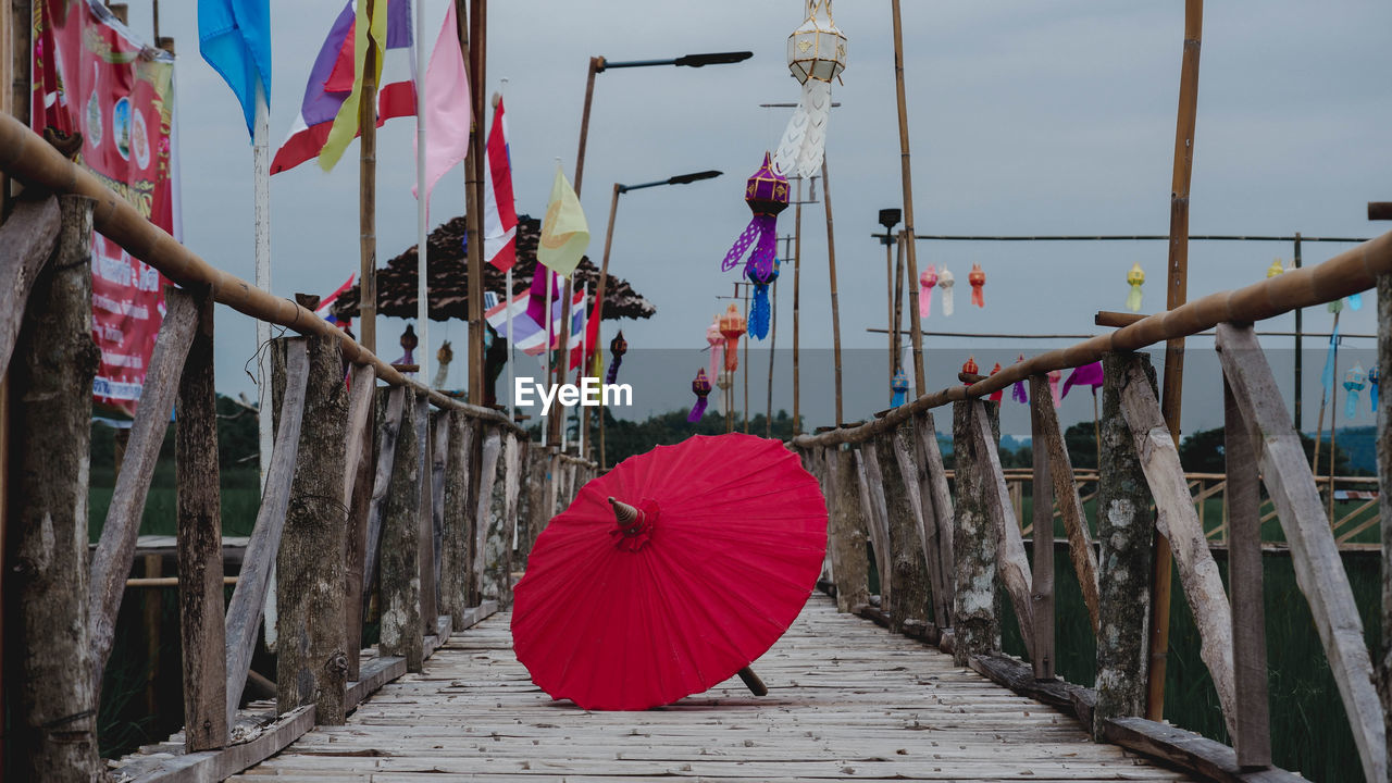 Multi colored umbrellas hanging on footpath