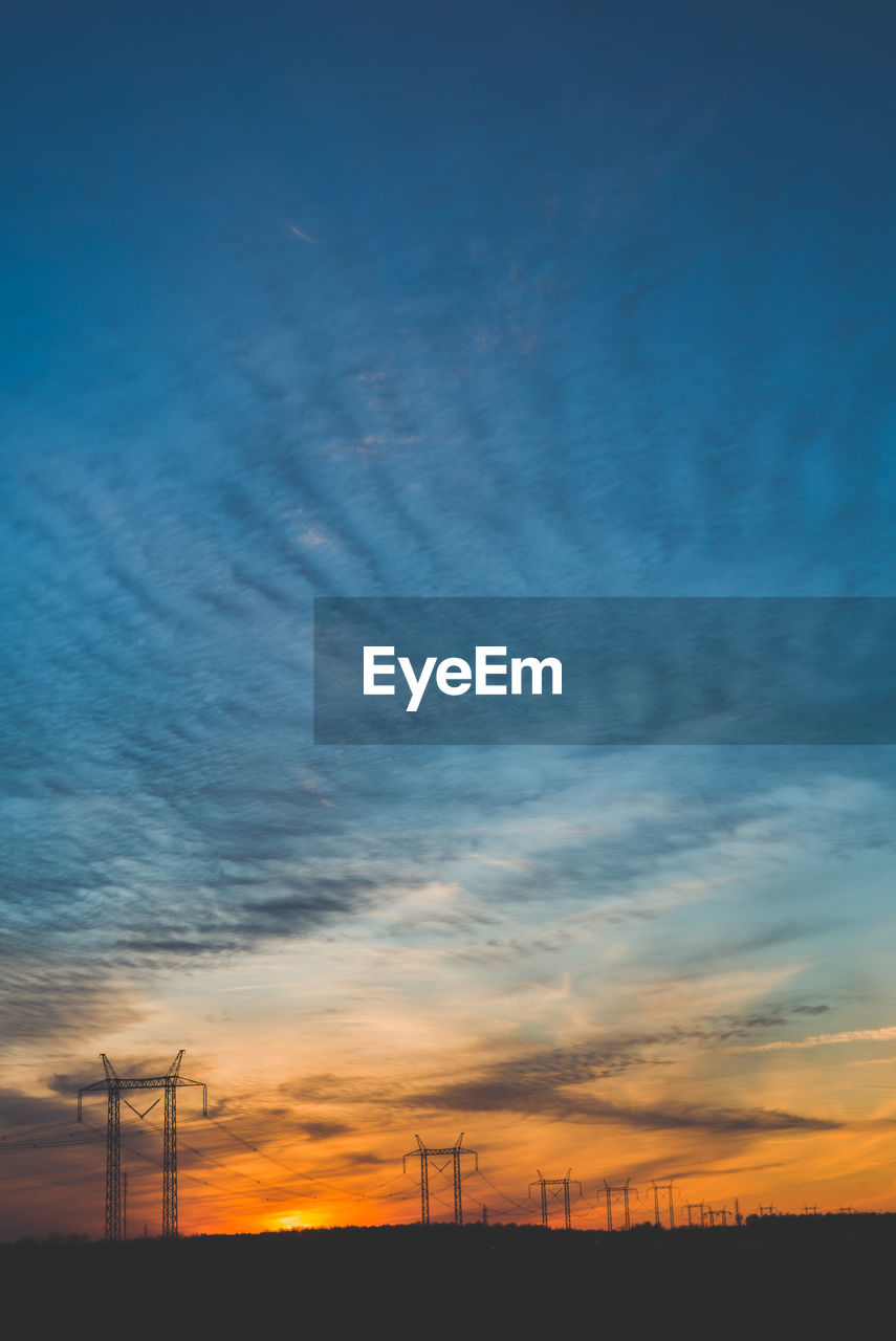 Low angle view of electricity pylon against sky