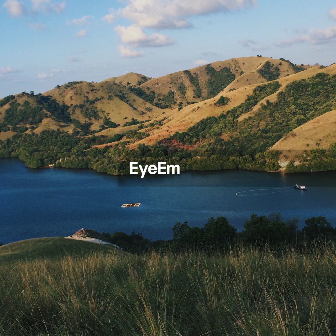 Scenic view of lake and mountains against sky