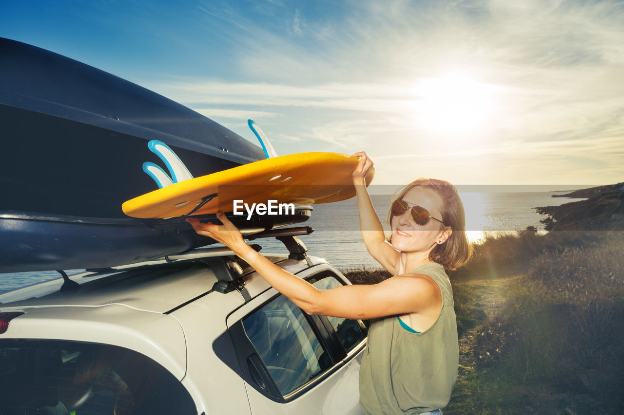 cropped image of woman holding steering wheel in car