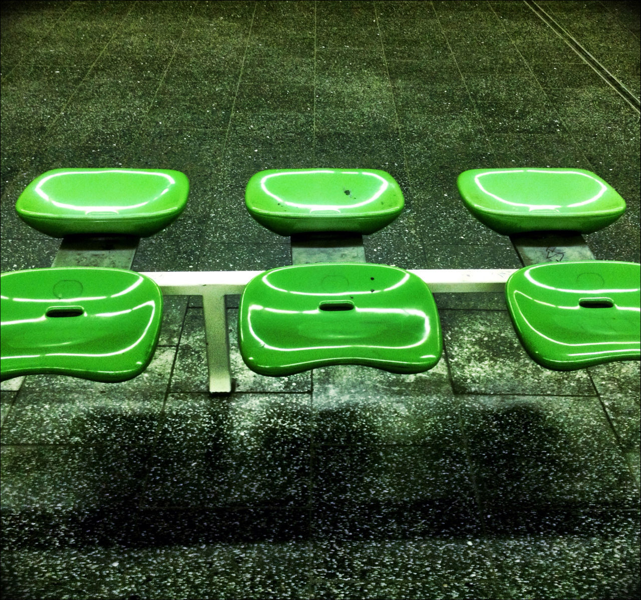 Green seats on sidewalk