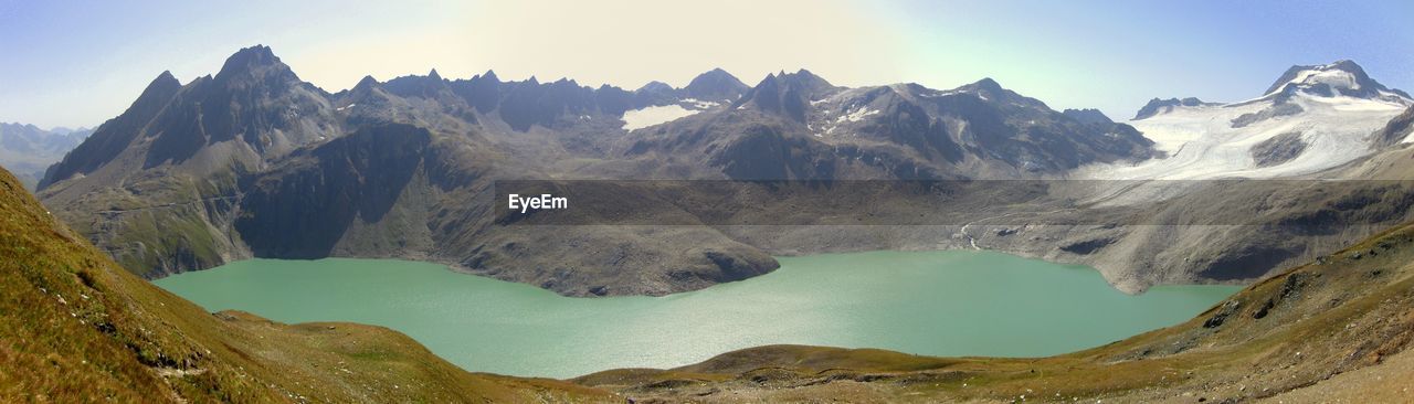 Panoramic view of lake and mountains against clear sky