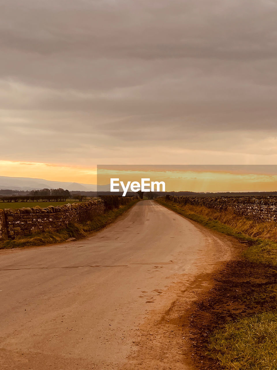 sky, cloud, horizon, landscape, nature, environment, land, scenics - nature, natural environment, beauty in nature, sunset, road, tranquility, sand, the way forward, no people, tranquil scene, sea, non-urban scene, coast, plant, field, sunlight, hill, outdoors, plain, grass, dramatic sky, transportation, dawn, dirt road, soil, rural area, orange color, prairie, remote, dirt, travel, vanishing point, day, water, idyllic, horizon over land