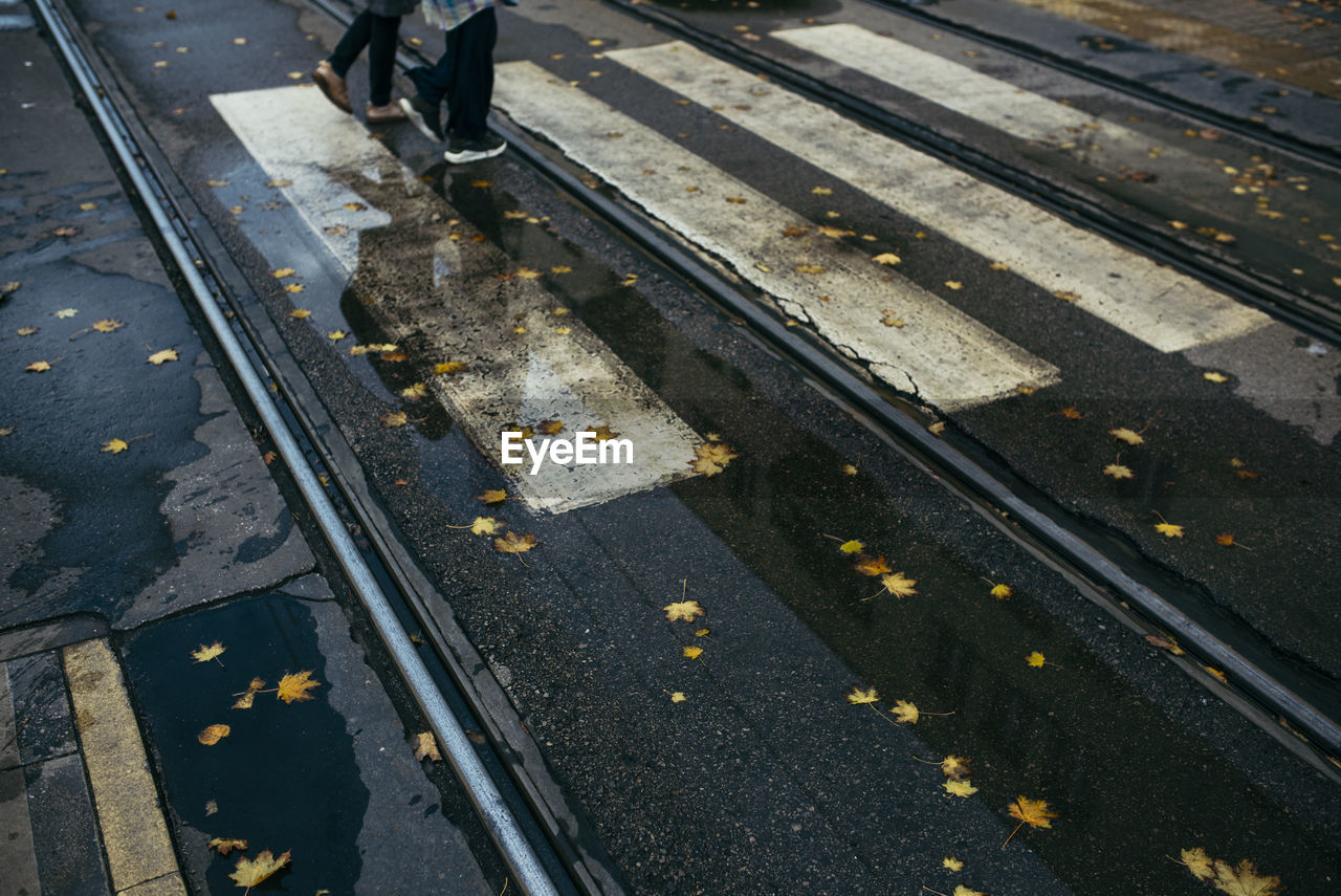 Low section of person walking on railroad track