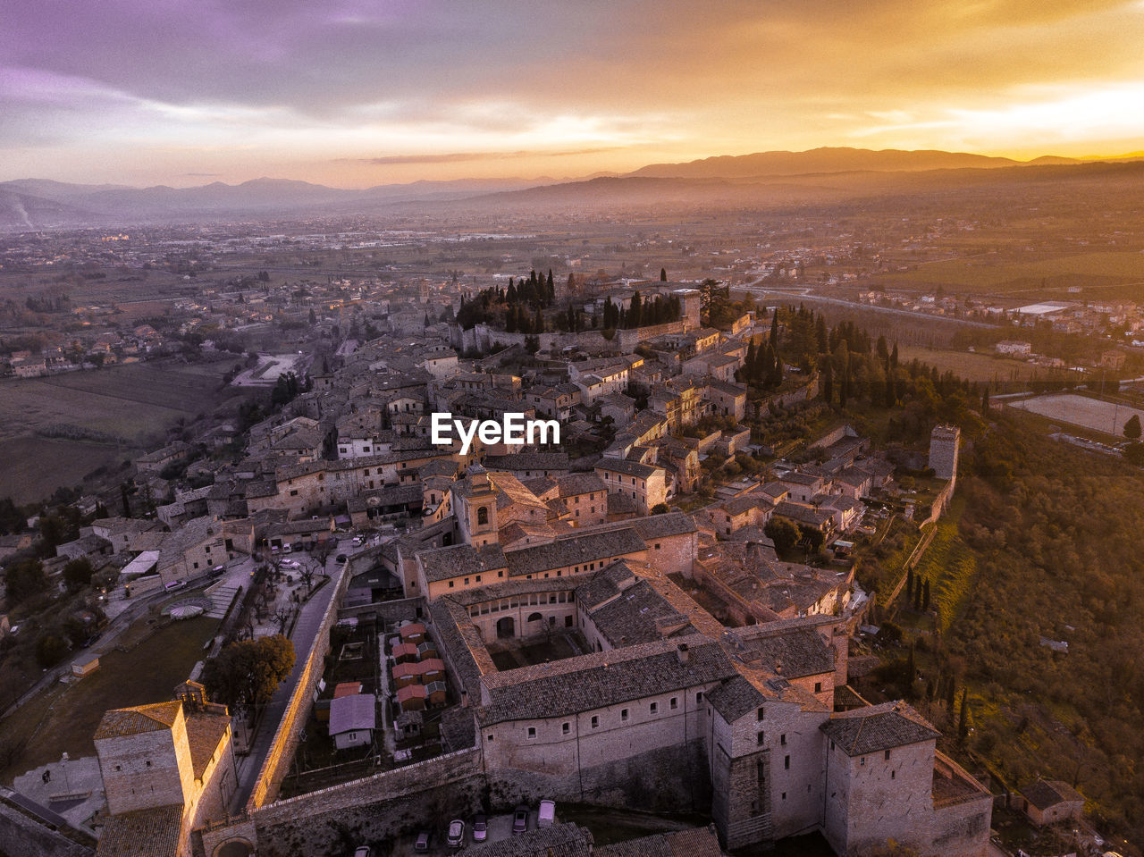 High angle view of city buildings at sunset