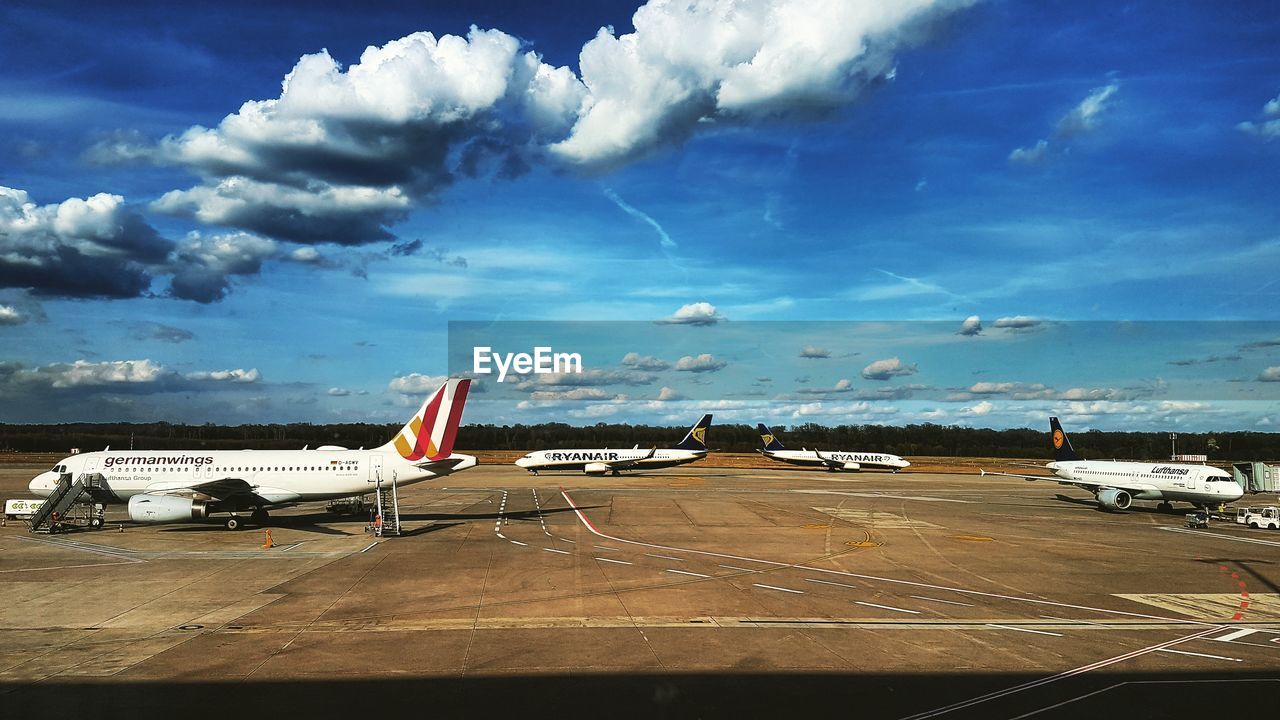 AIRPLANE FLYING OVER RUNWAY