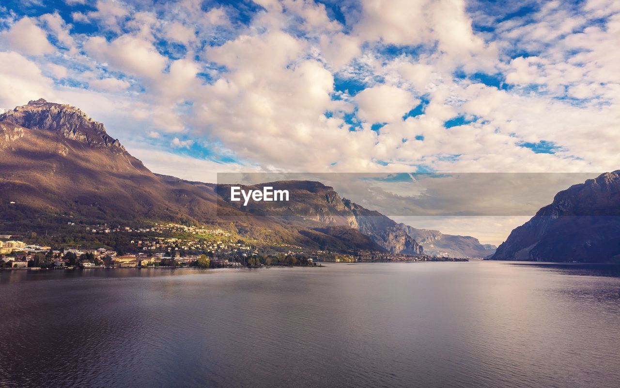 Scenic view of como lake and mountains against sky