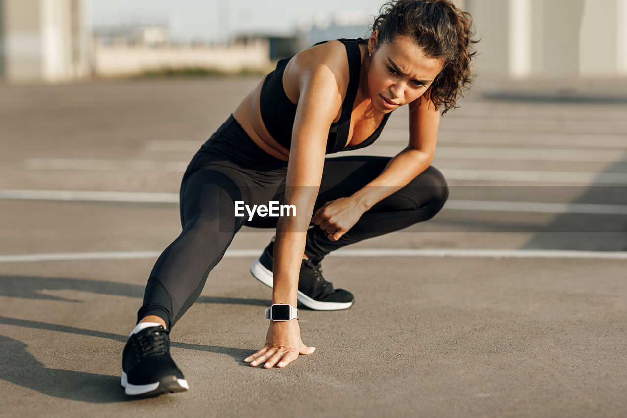 Full length of young woman exercising outdoors