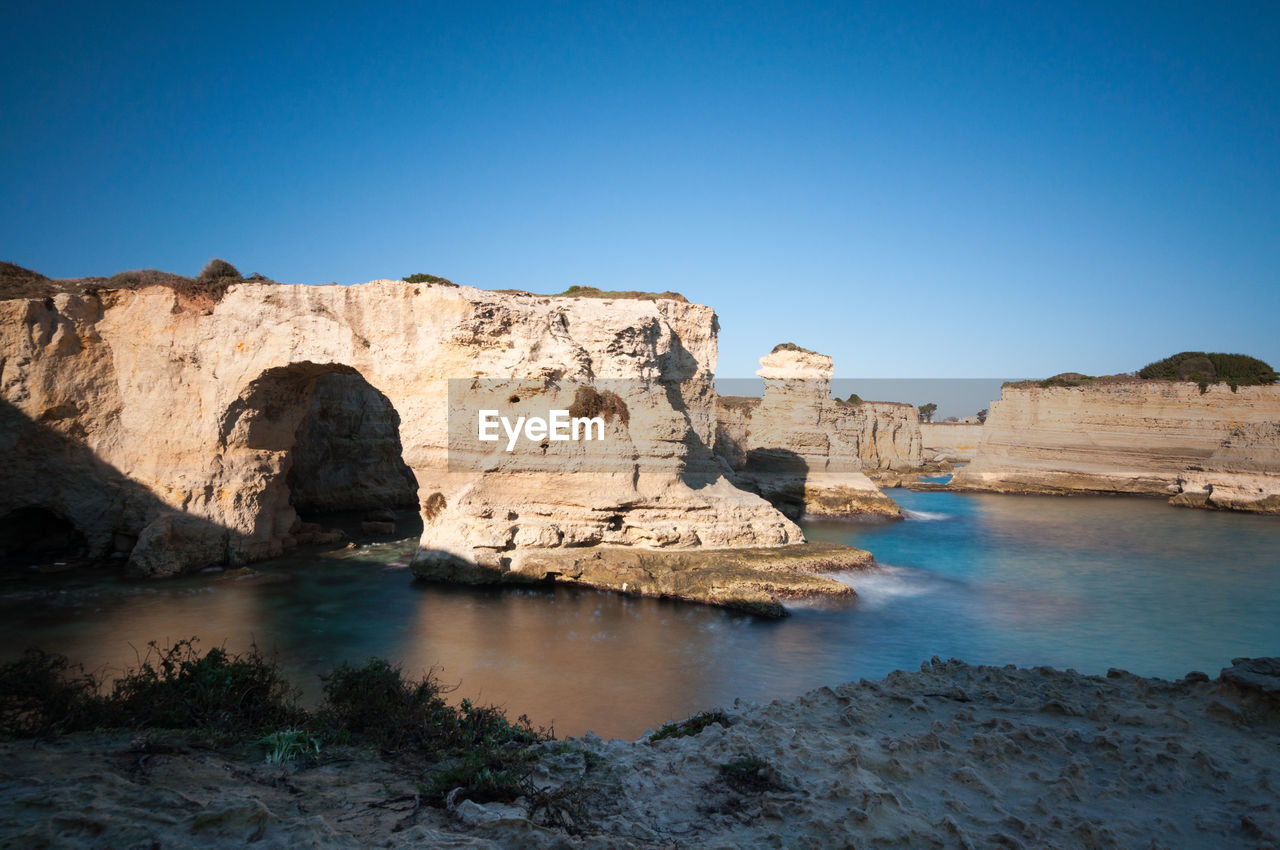 Scenic view of rock formation against clear blue sky