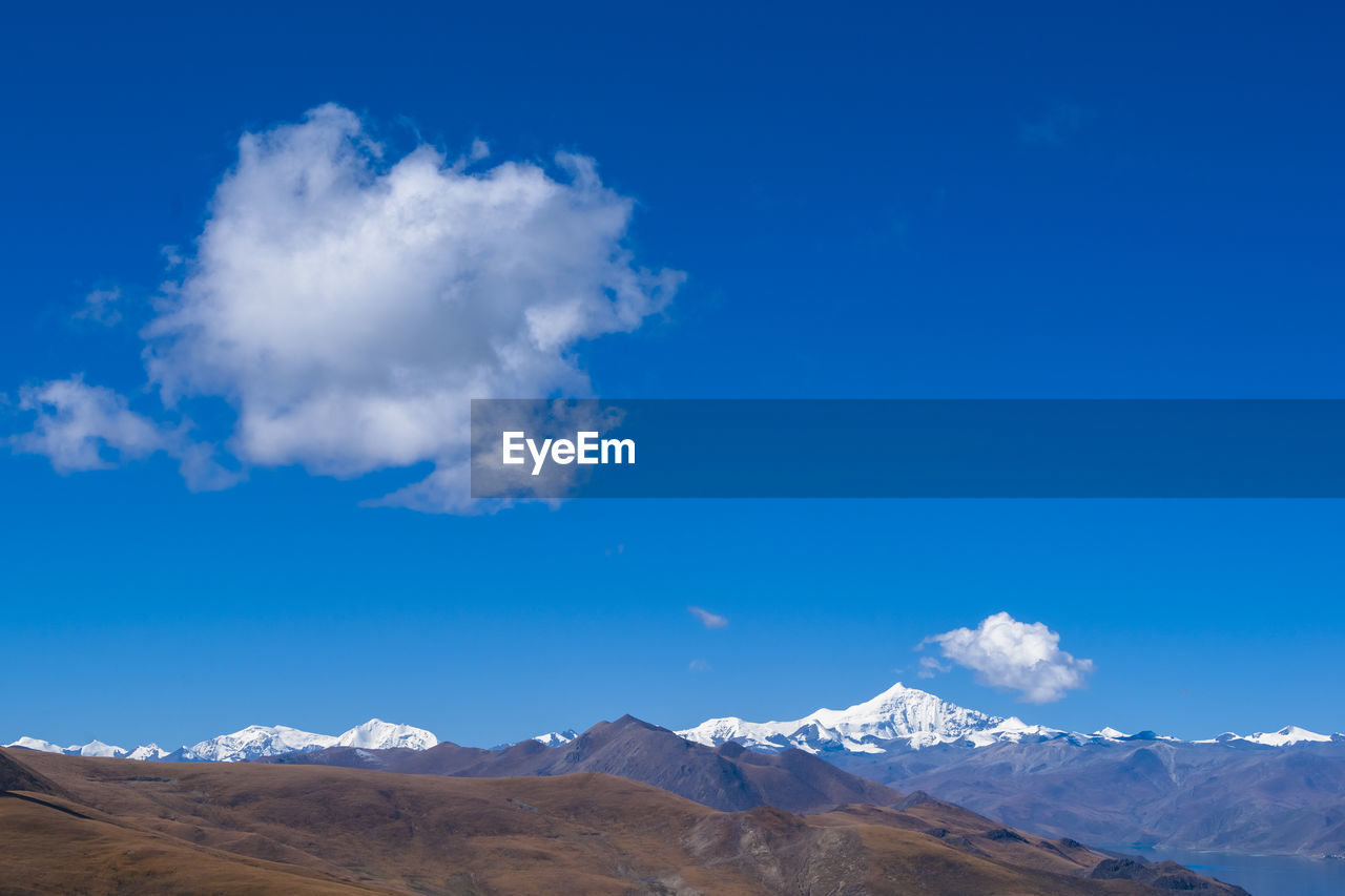 SCENIC VIEW OF MOUNTAINS AGAINST BLUE SKY