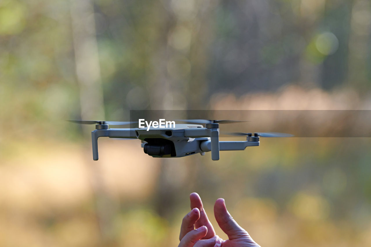 Quadcopter drone on operator hand. small drone land on hand after taking video and photos