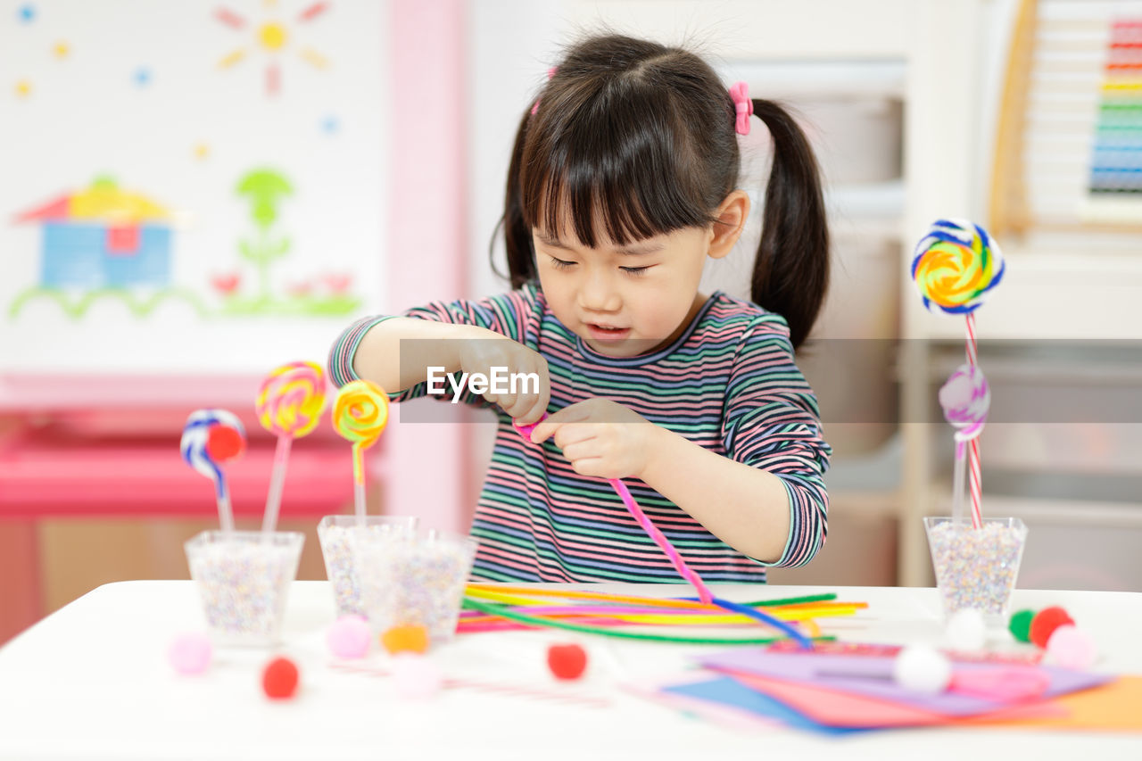 Young girl making craft for homeschooling