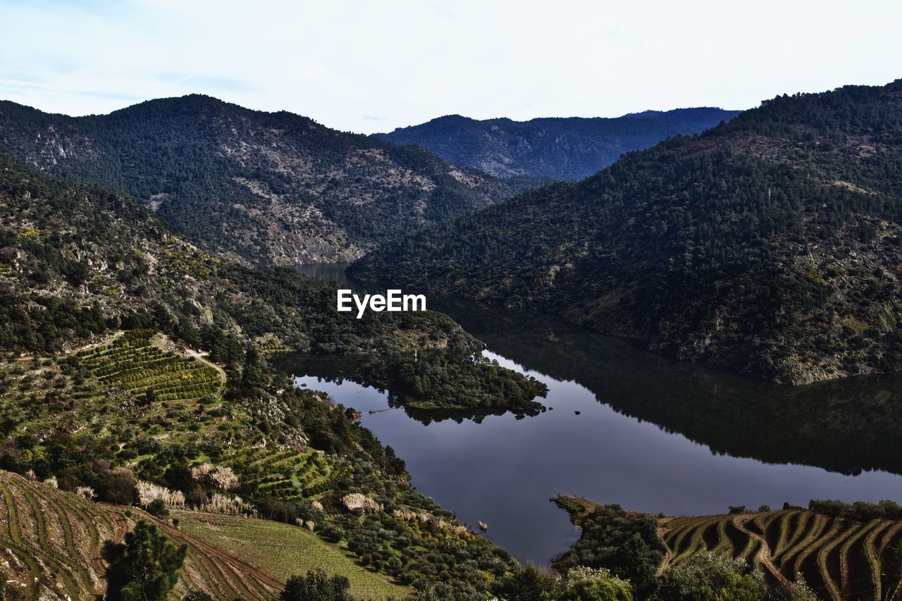 Scenic view of lake and mountains against sky