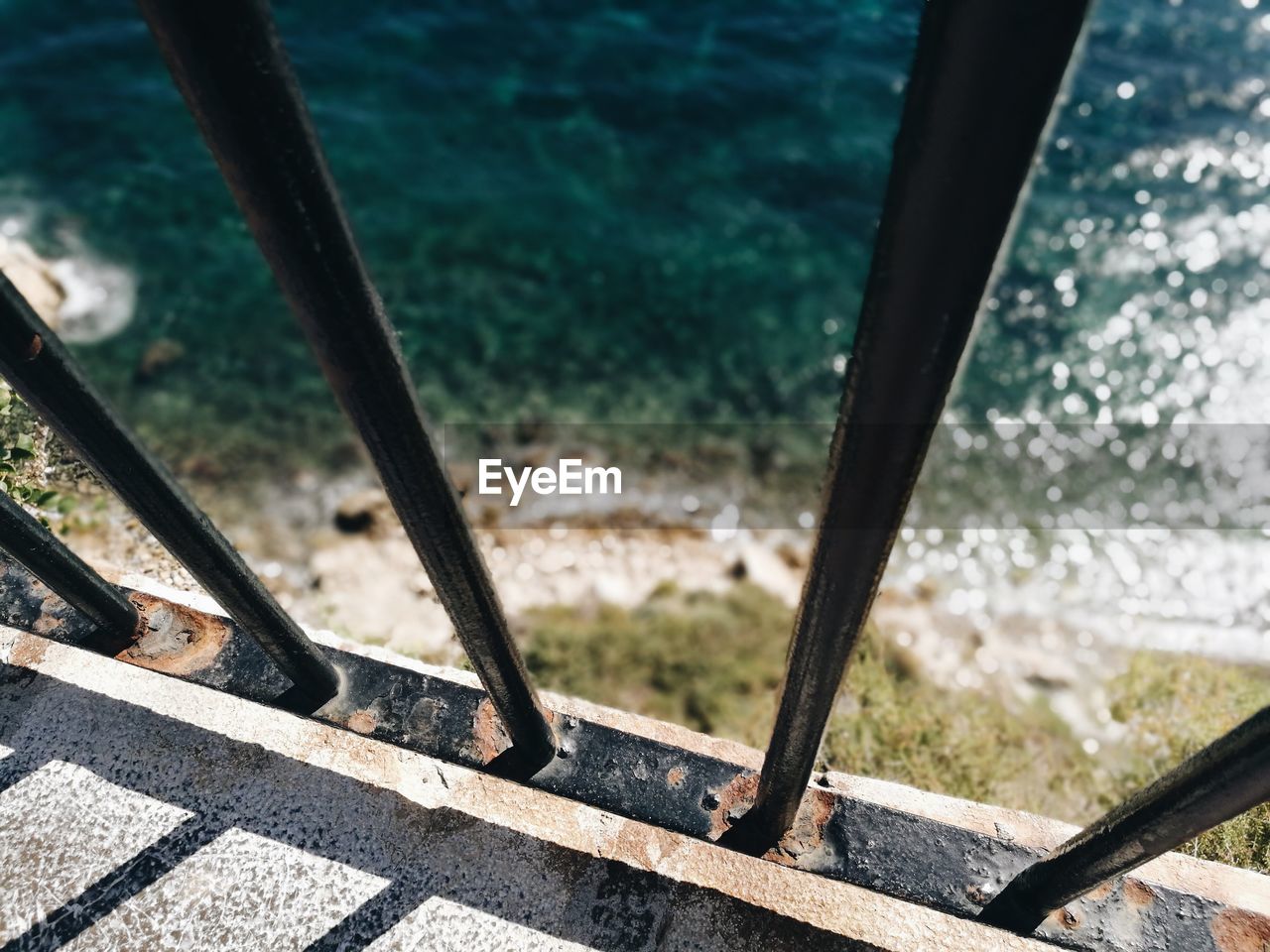 HIGH ANGLE VIEW OF RAILING BY ROAD