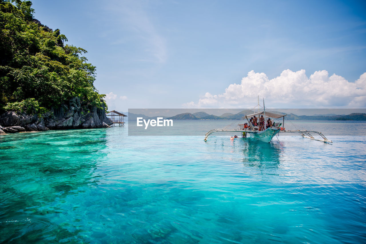 Tourist enjoying the clear turquise waters of coron, palawan, philippines.