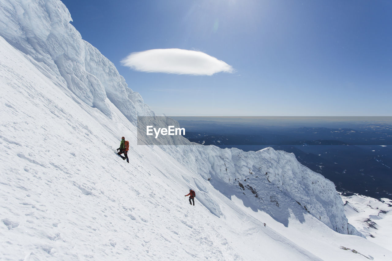 A man climbs down from the summit of mt. hood in oregon.