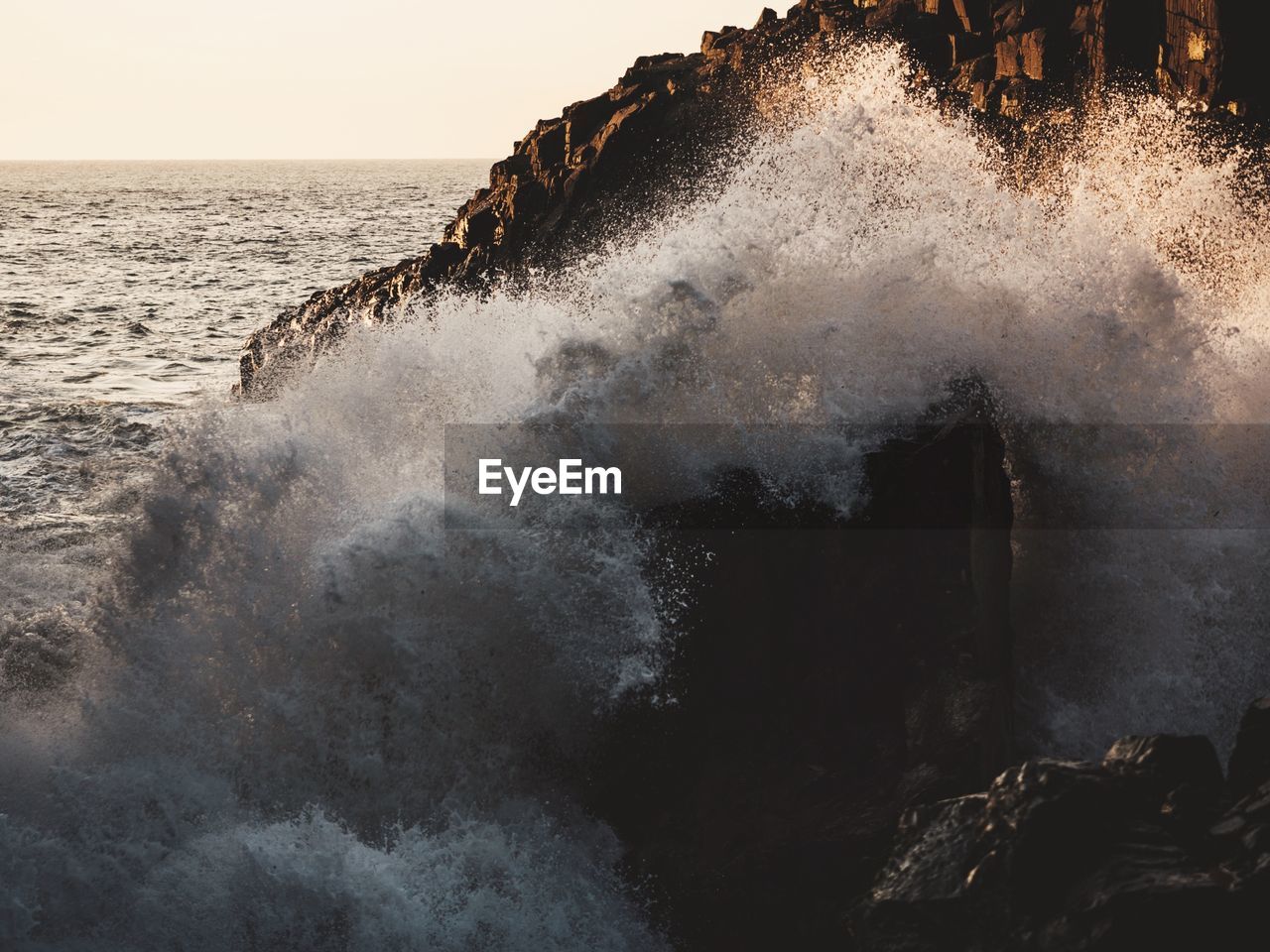 Waves splashing on rocks at shore