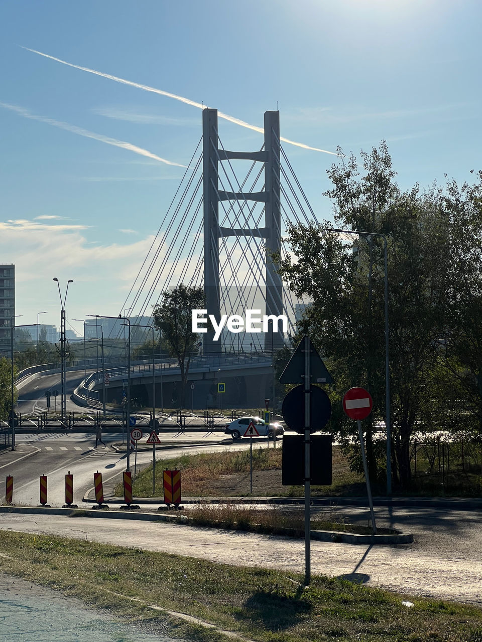 architecture, sky, built structure, transportation, transport, nature, city, urban area, bridge, cloud, tree, building exterior, cable, road, day, plant, outdoors, street, travel destinations, no people, travel, sunlight, mode of transportation, electricity