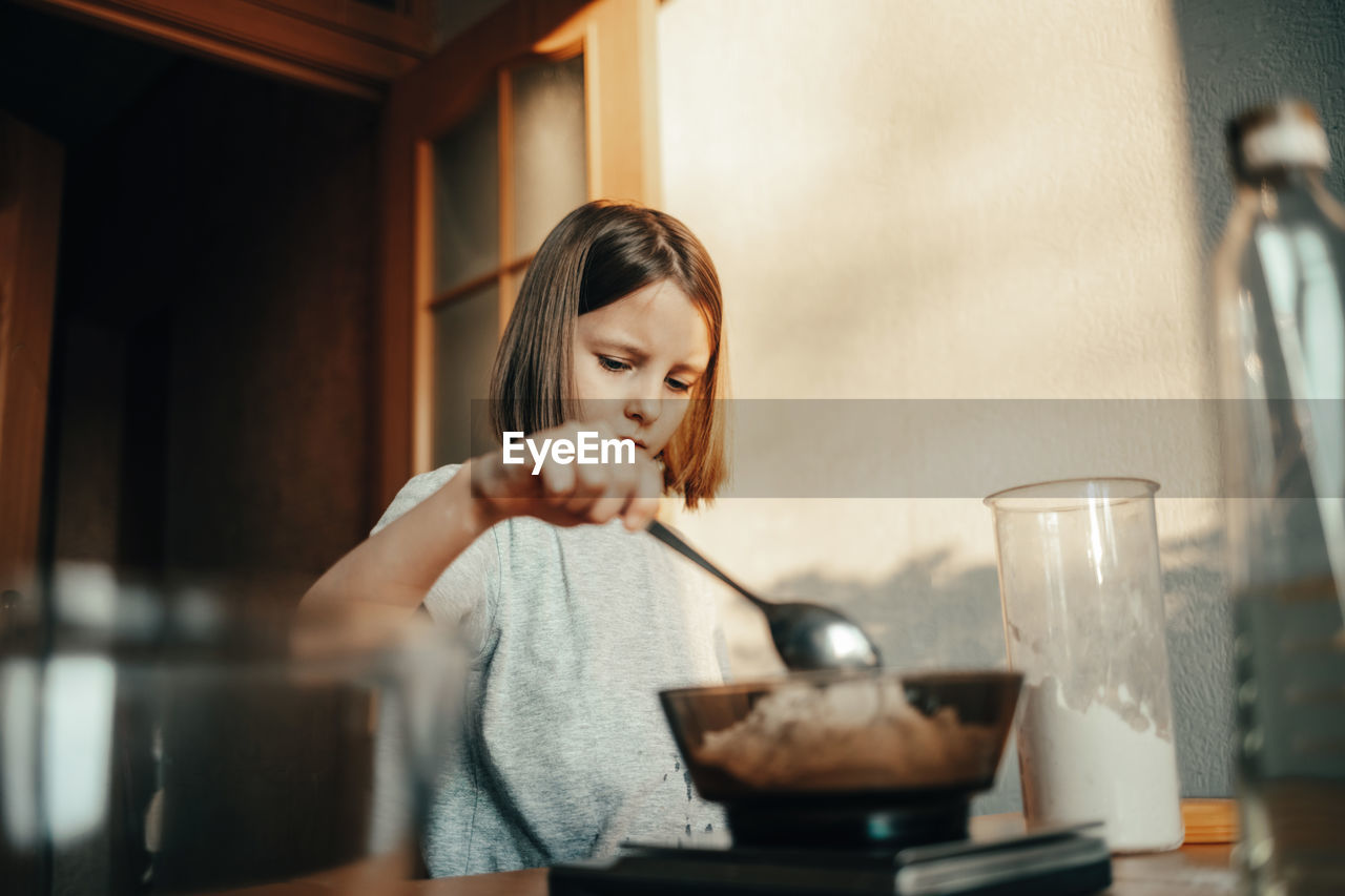 Cute girl cooking at home