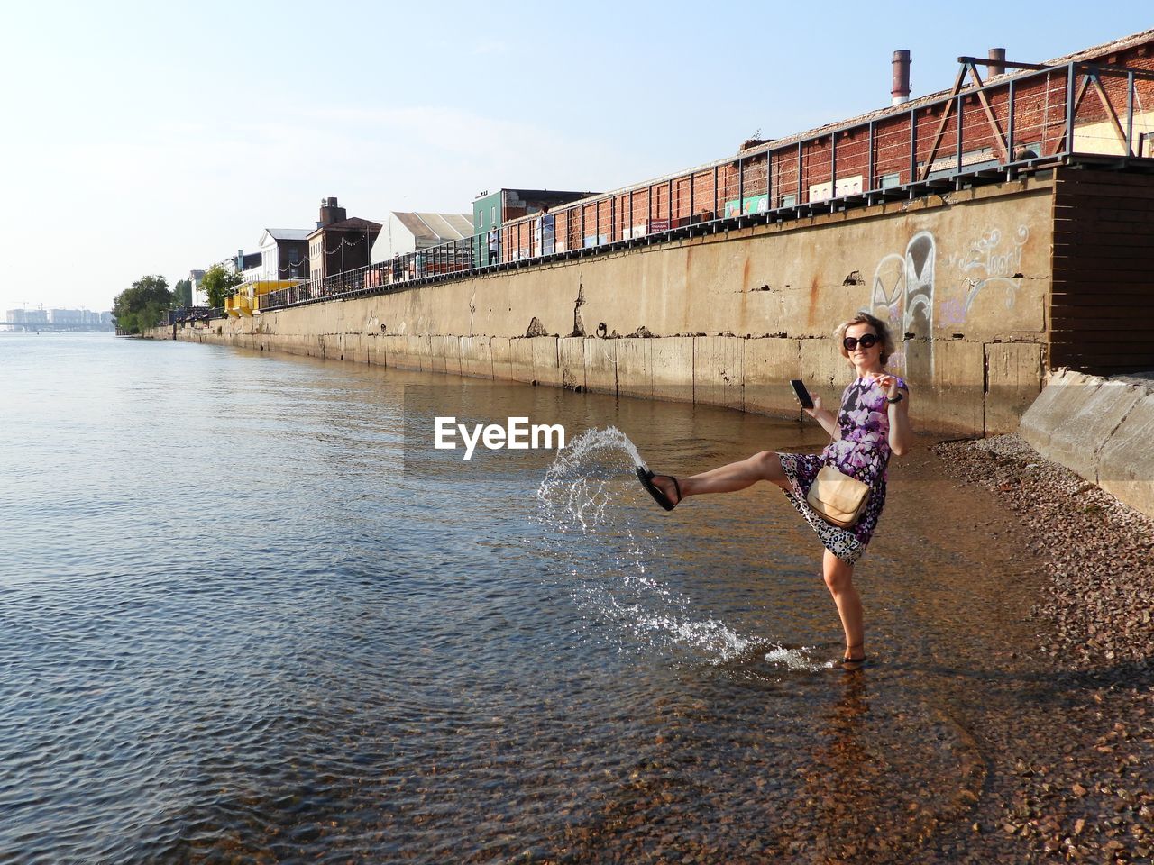 water, architecture, full length, nature, one person, built structure, sky, lifestyles, motion, sea, day, adult, building exterior, leisure activity, vacation, young adult, women, sports, city, outdoors, casual clothing, sunlight, person, clothing, vitality, men