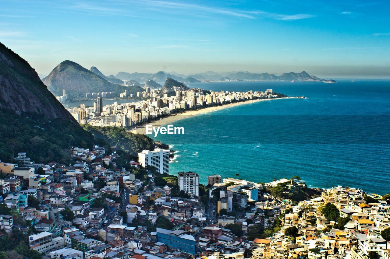 High angle view of buildings and sea against sky