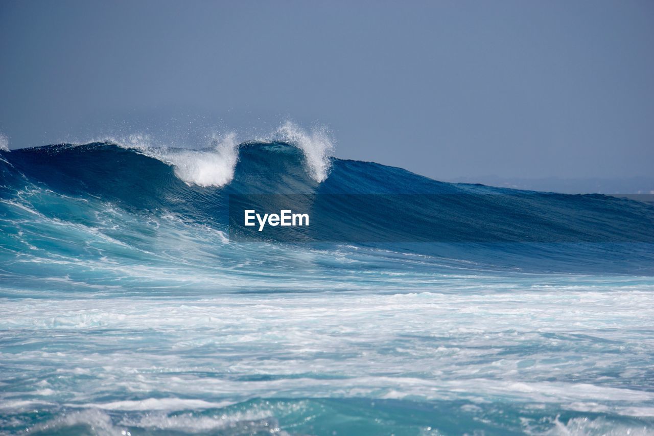 Scenic view of sea against blue sky