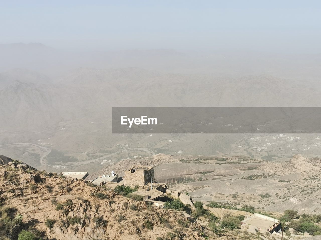 environment, landscape, mountain, scenics - nature, valley, nature, plateau, fog, architecture, land, beauty in nature, mountain range, no people, wadi, travel, travel destinations, built structure, tranquility, sky, day, building exterior, outdoors, building, history, high angle view, non-urban scene, tranquil scene, geology, ancient, tourism, plant, the past, tree, natural environment, snow, remote, rural scene, desert, climate, village