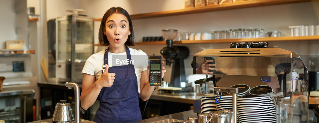 portrait of young woman standing in cafe