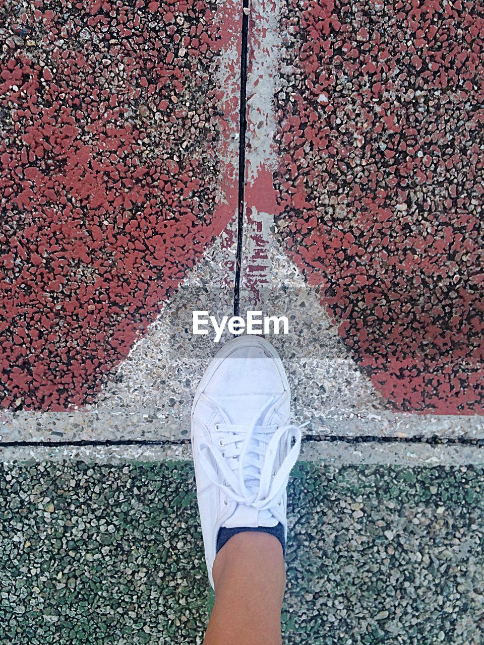 High level view of tennis shoe on asphalt pitch floor