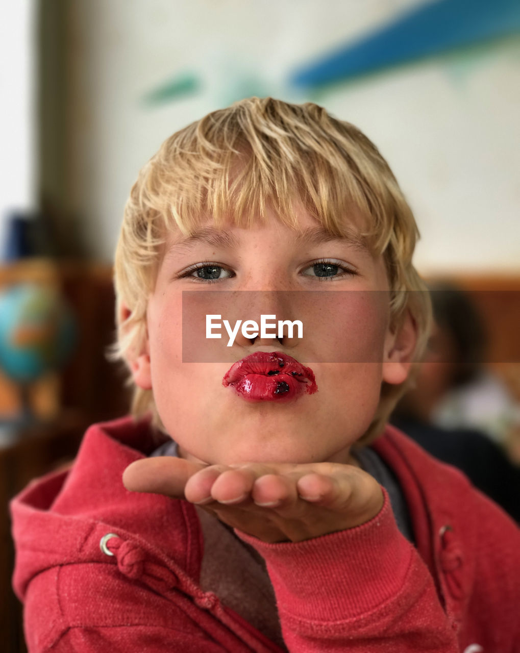 Close-up portrait of boy blowing kiss