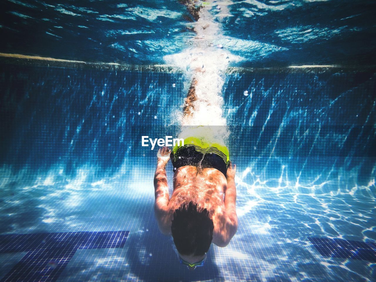 Boy swimming in pool