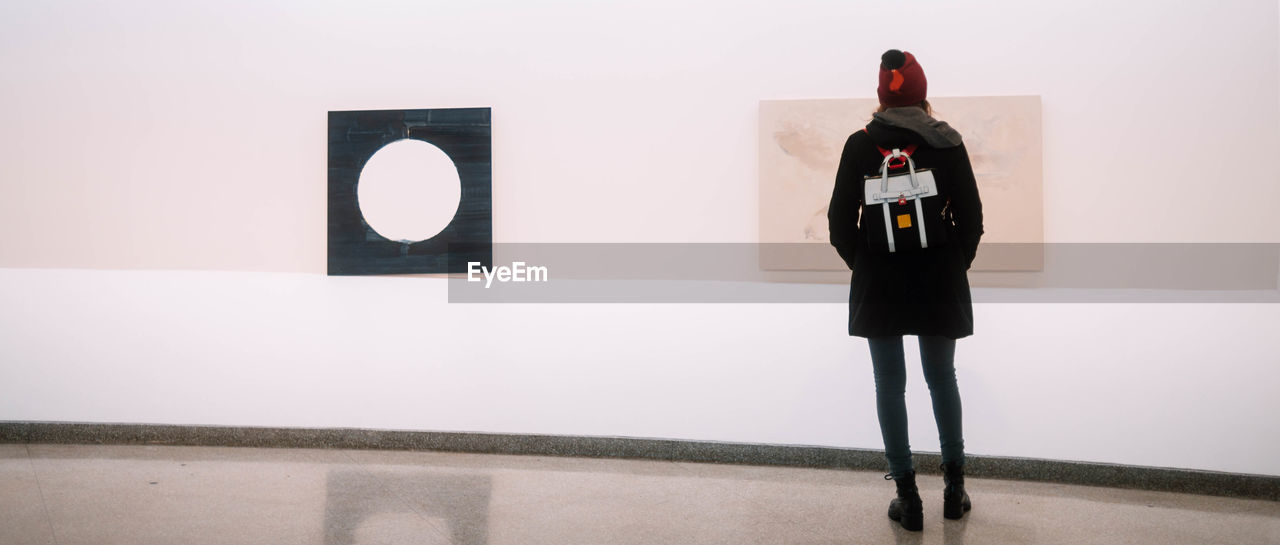 FULL LENGTH OF WOMAN STANDING IN MUSEUM